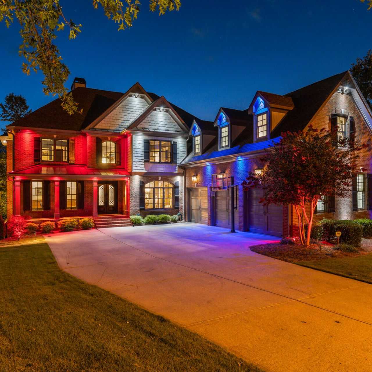 Illuminated two-story house at night.