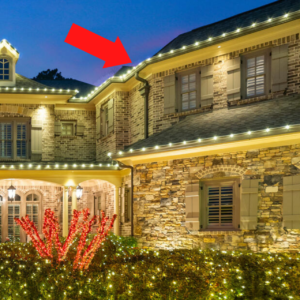 Illuminated home exterior with festive lights at dusk.