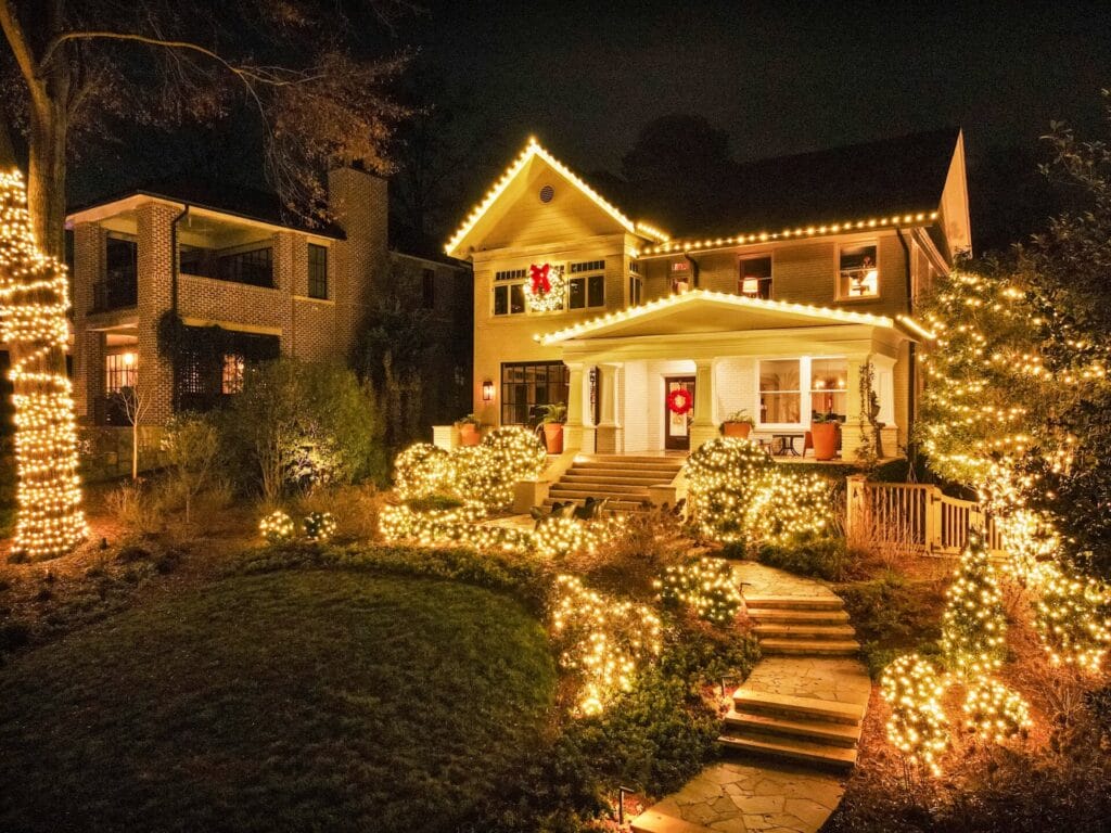 House adorned with festive holiday lights at night.