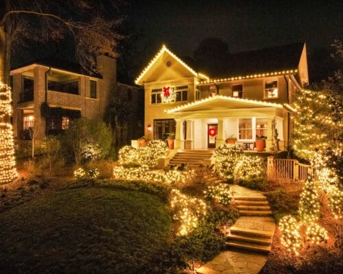 House adorned with festive holiday lights at night.