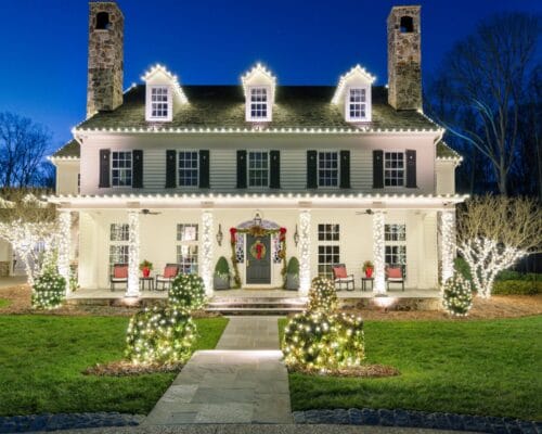 House with festive holiday lights at night.
