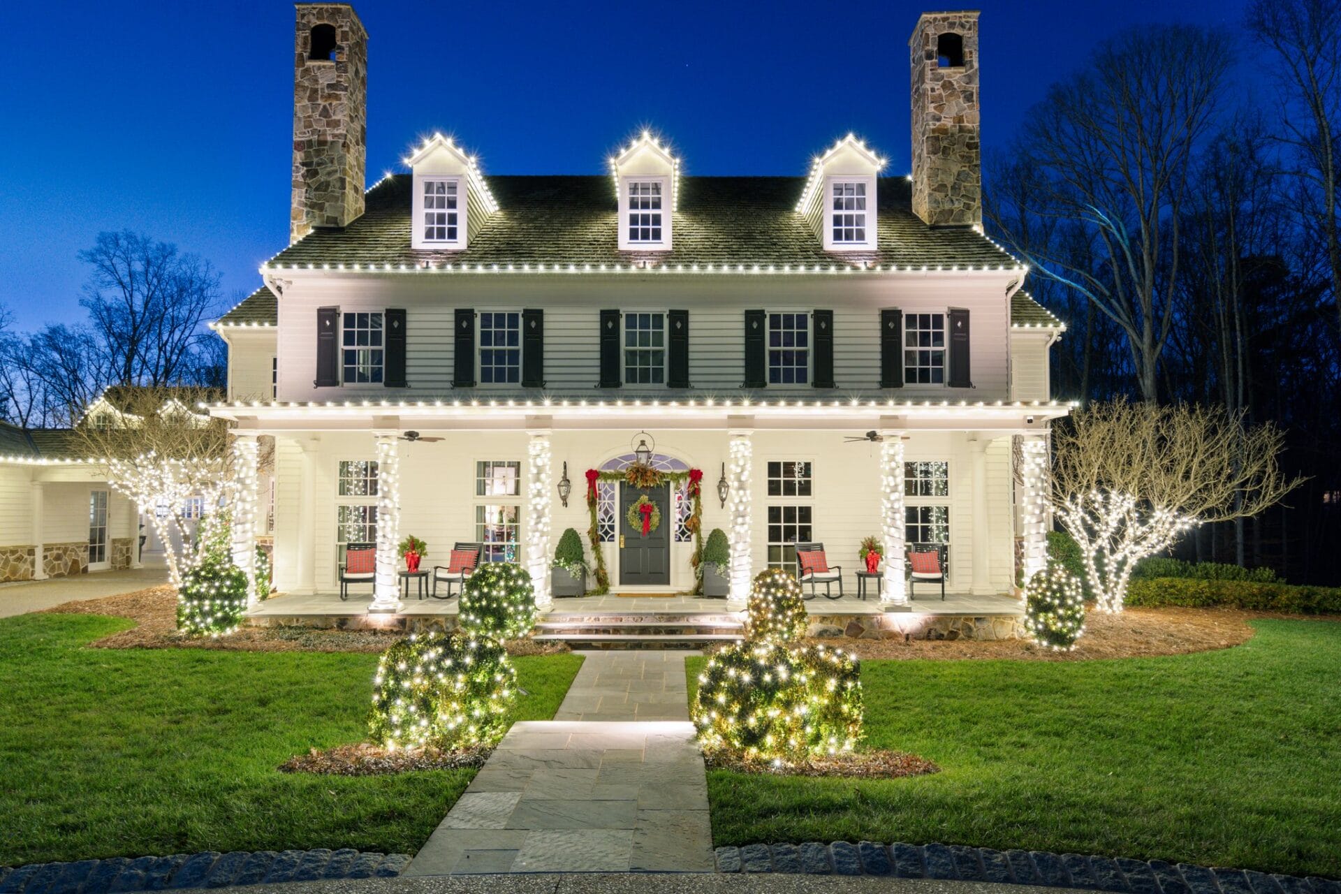 House with festive holiday lights at night.
