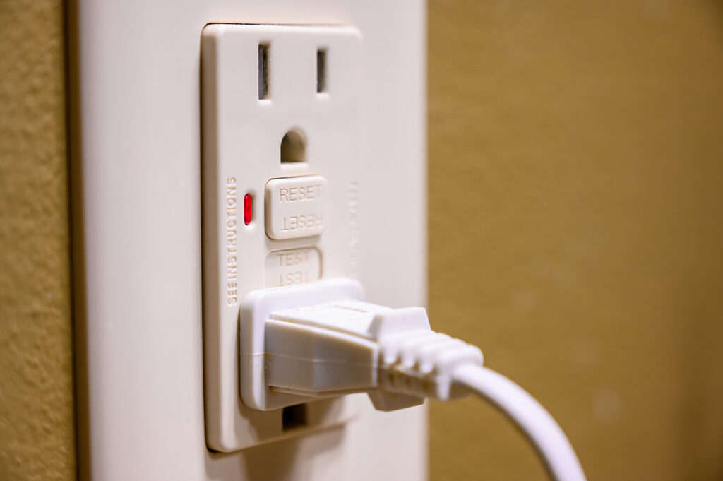 Plugged-in GFCI electrical outlet close-up