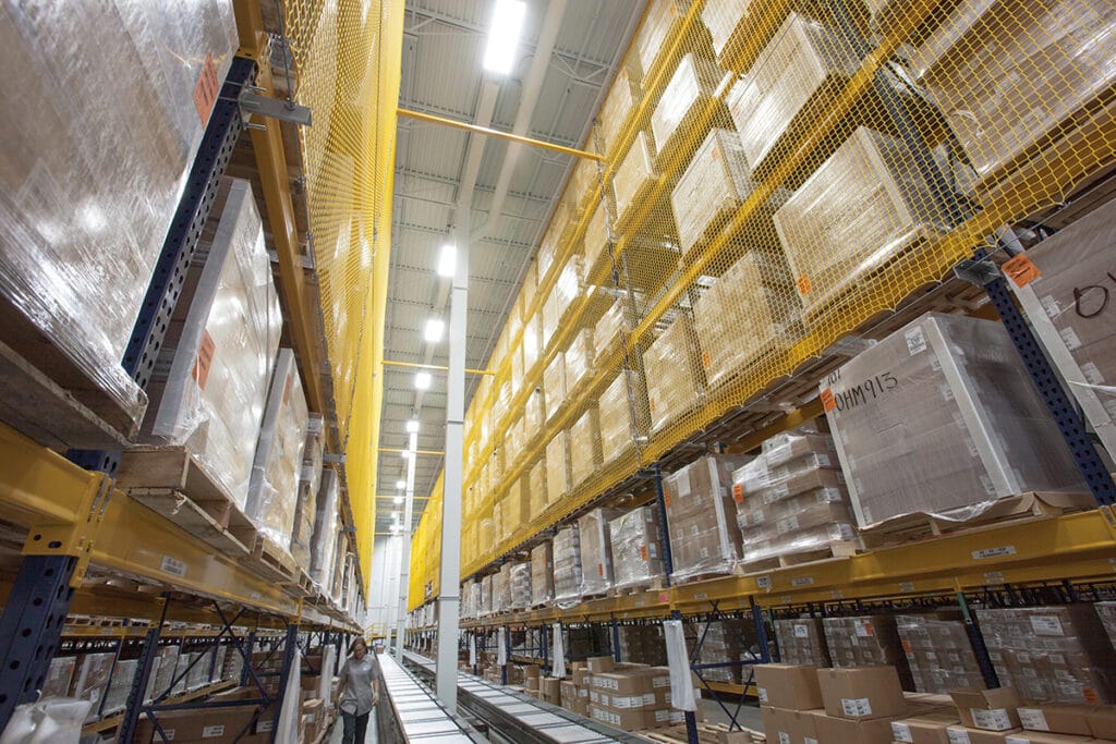Warehouse shelves with boxes and safety netting