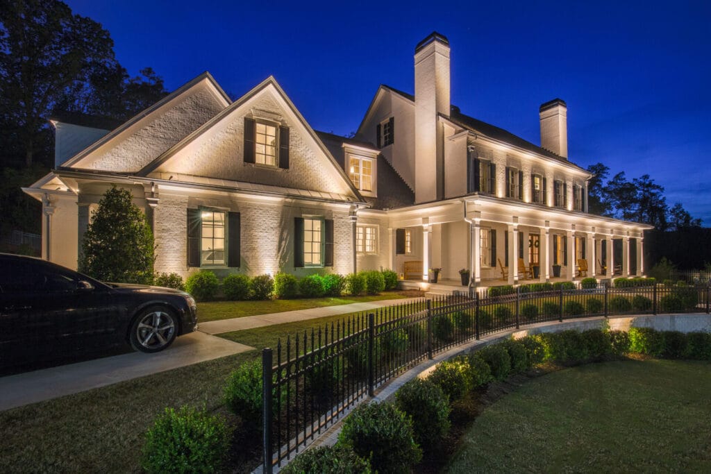 Illuminated two-story brick house at night