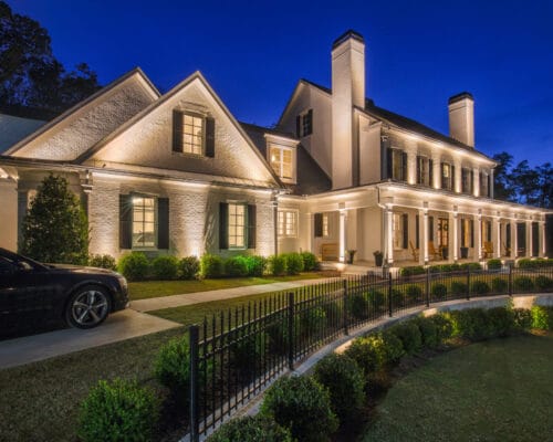 Illuminated two-story brick house at night