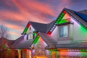 House decorated with colorful Christmas lights at sunset